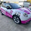 Custom car signage Melbourne with full vehicle wrap showcasing business branding on city roads