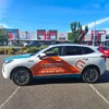 Professional full car wrap installation being applied to a sedan in Melbourne workshop