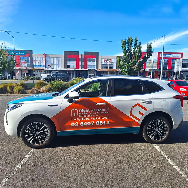 Professional full car wrap installation being applied to a sedan in Melbourne workshop